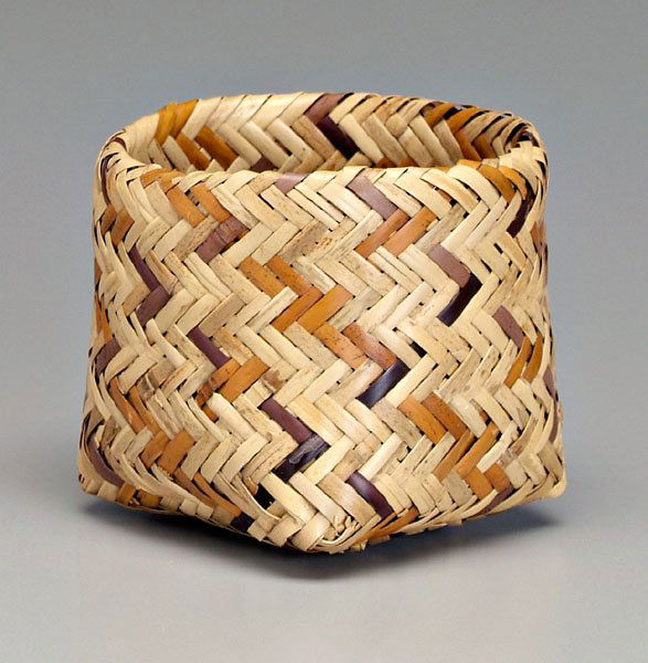 Cherokee river cane basket,: double woven, square-to-round, two colors of natural dyes, attached tag "Eva Bigwitch", mid to late 20th century, 5-1/4 in. Several minor surface breaks. Provenance: Private Collection, Newnan, Georgi