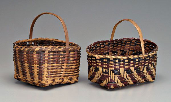 Two Cherokee river cane baskets,: both with notched bentwood handles, cane rims: one with broad diagonal dark brown weavers, 9-1/4 in., [excellent condition, minor base wear;] one with square base, vertical bands of dark brown decorat
