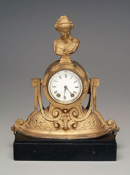 Seth Thomas shelf clock,: cast metal Victorian case, pediment with female bust, face marked "Seth Thomas Sons & Co. N.Y.", key wind, with key, 17 in. including polished slate base. Later gold paint with chips and losses, lacki