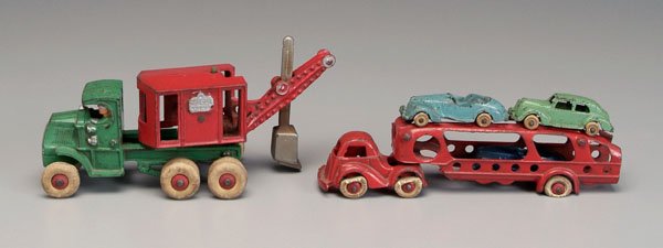 Toy steam shovel, car carrier,: both cast iron: Hubley pivoting red steam shovel marked "General" on tractor cab, inside cab marked "Hubley" and "1897", ten white rubber tires, 10 in., [minor paint wear;] three-car two-piece carrier