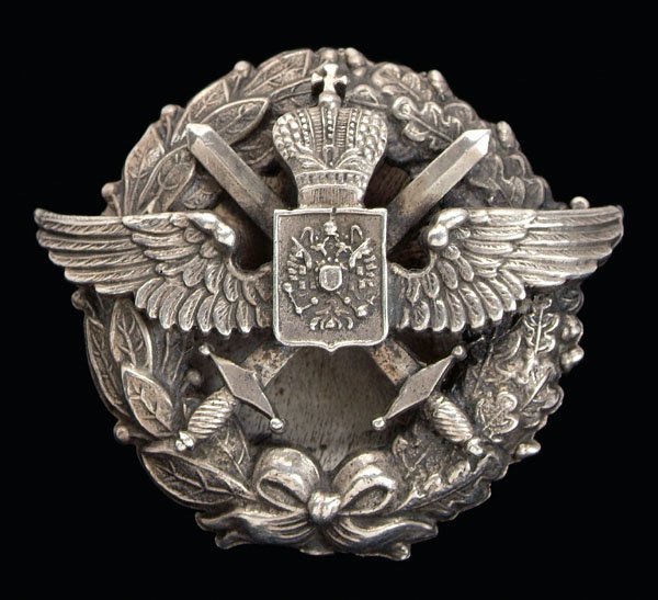 Russian silver helmet insignia,: floral wreath with wings, crossed swords, marked "F.?.", test .800 fine, 1-3/4 x 1-1/2 in. Good condition.