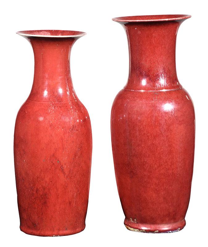Two Chinese Sang de Boeuf Floor Vases: Qing dynasty, porcelain vases glazed in oxblood red, one with black character mark to base, 22-5/8 in.; tallest 24-1/2 in. - Provenance: Private Collection