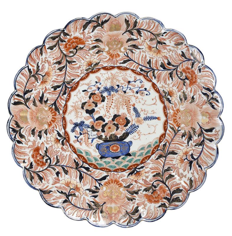 Large Japanese Imari Porcelain Platter: possibly Meiji period, decorated with flower vase surrounded by scrolling peony blossoms and mask decoration,˜iron red, blue, and gilt decoration, scalloped rim, 18-1/8 in. - Provenance: Private Coll