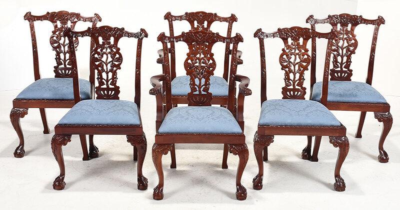 Set Six Chippendale Style Carved Dining Chairs: 20th century, each elaborately carved mahogany frame with blue damask upholstered slip seats, two arm and four side, armchair height 39-3/4 in. - Provenance: Private Collection