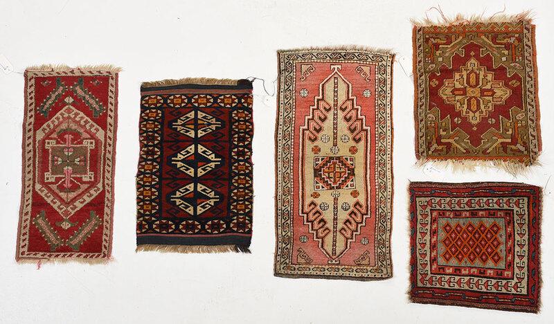 Five Turkish Mats: Kurdish/Anatolian, early 20th century, geometric designs with central medallions, reds, salmons, rust, greens throughout, 1 ft. 7 in. x 1 ft. 6 in. to 2 ft. 10 in. x 1 ft. 6 in. - Provenance: Property