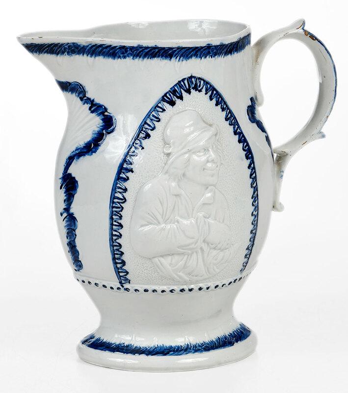 Blue and White Prattware Relief Molded Jug: British, early 19th century, possibly Staffordshire, pearlware jug press molded with portrait of "miser" to both sides, 8-5/8 in. - Provenance: Property from the Collection of Dudley and Constance God