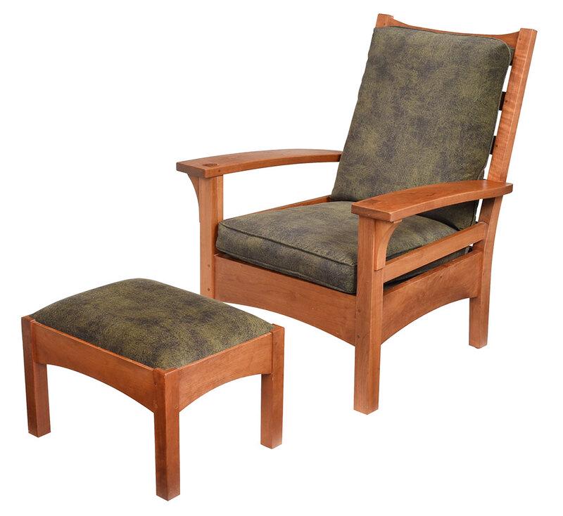 Stickley Arts and Crafts Armchair and Footstool: each with branded mark and metal tag for Stickley, produced 2006, armchair with slat back, figured cherry throughout, microsuede upholstery with matching footstool, 39-1/2 x 32 x 30 in. - Provenance: 