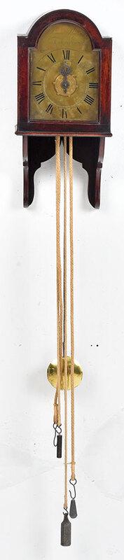 Signed Hanging Wall Clock: British, 19th century, arched brass dial signed "James Shilling Boughton", engraved floral spandrels, brass works, wooden shelf and arched case, with rope chain, pendulum, and lead weights, 19 in. - P