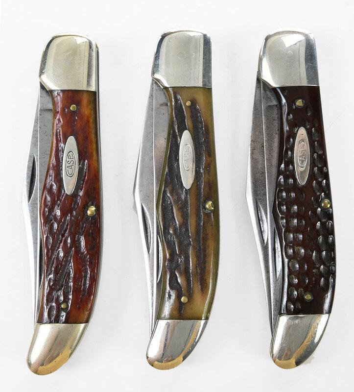 Three Vintage Case Knives: 1940-1964, two blade folding hunter, marked "CASE/XX", blade 4-1/4 in., closed 5-1/4 in.Note: One knife comes in a red bone handle, another in a deep red bone handle, and the third in a green bone han