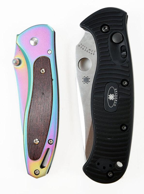 Two Tactical Knives: Spyderco and S&W: Spyderco CPM S30V folding knife, black handle, lanyard hole, pocket clip, blade 3-3/4 in., padded Spyderco zip case;˜Smith & Wesson "Reflection" folding knife, rainbow finish, dual thumb studs, wood