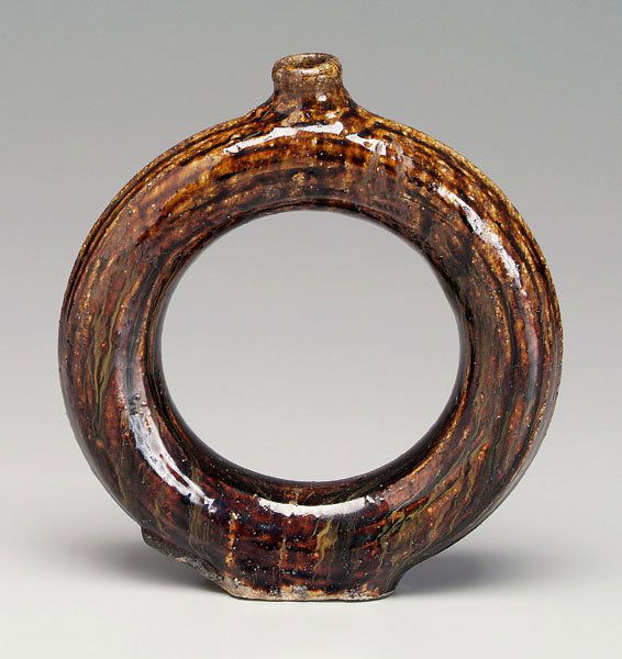 Stoneware ring jug,: mottled dark brown alkaline glaze, incised concentric rings, probably Southern, possibly Stone or Penland pottery, Buncombe County, North Carolina, 19th century, 10-1/4 in. Glaze pooling, base with so
