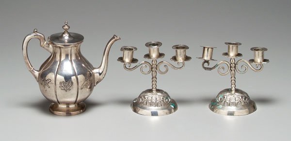 Three pieces Mexican silver:: pair three-cup candelabra, tested .900 or better, 6-1/2 x 6-3/4 in., [base and rims bent, repaired arm;] sterling coffeepot, floral and animal scenes, 8-1/4 in., [rims bent.]