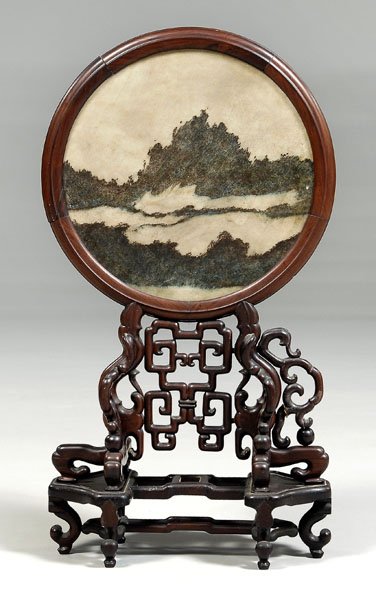 Chinese dreamstone screen,: circular stone panel in hardwood frame with matching stand, late 19th/early 20th century, 33-3/4 in. Breaks and repairs to frame and fretwork, lacking several fretwork elements and center panel on sta