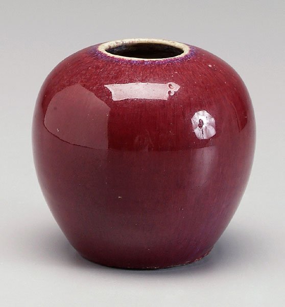 Chinese [sang de boeuf] vase,: rich strawberry glaze with white rim, late 19th/early 20th century, 3-3/4 in. Chips to base as made, minor scratches. Provenance: Private Collection, Greensboro, North Carolina