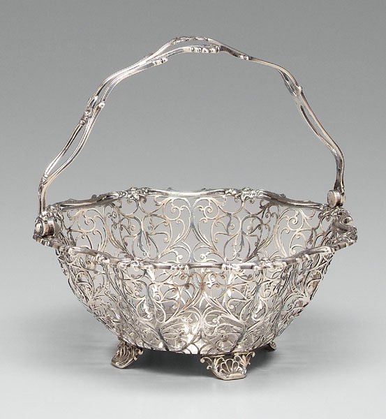Sterling silver basket,: openwork scroll sides, shell feet, floral and scroll borders, marked "6645" with marks for Roger Williams Silver Co. (Providence, Rhode Island, maker) and Henry Birk & Son (retailer), monogram, 20th c