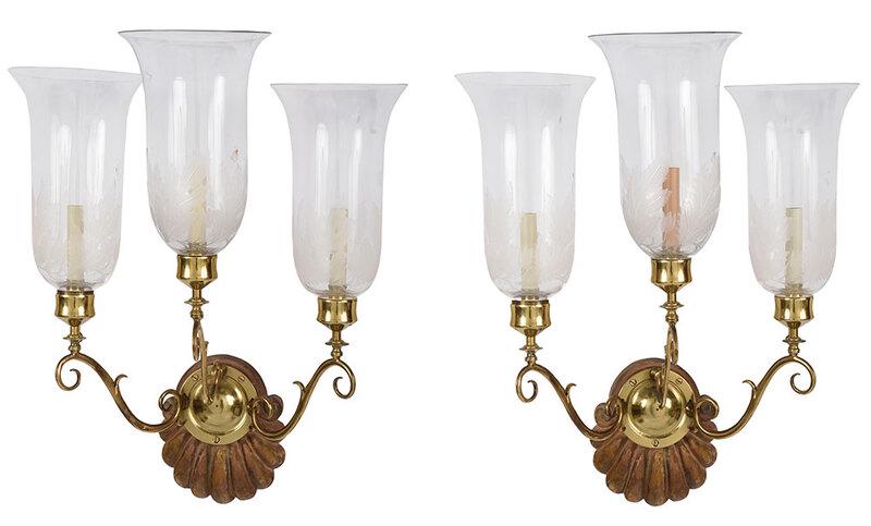 Pair of Georgian Brass, Etched Glass Wall Sconces: probably British, late 18th/19th century, each with shell carved backplate with brass disc supporting three scrolled candle arms, fitted with tulip form hurricane shades, etched floral and leaf desi