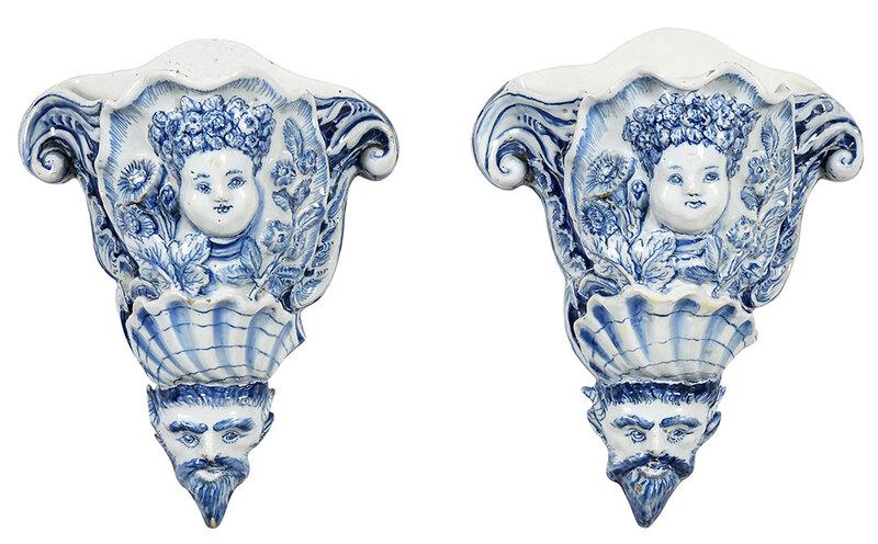 Pair of English Delftware Wall Pockets: probably Liverpool, mid 18th century, molded with mask of "Plenty" at top and satyr mask at terminal, with shell and floral decoration, back pierced with hole for hanging, 10-1/4 in. - Provenance: