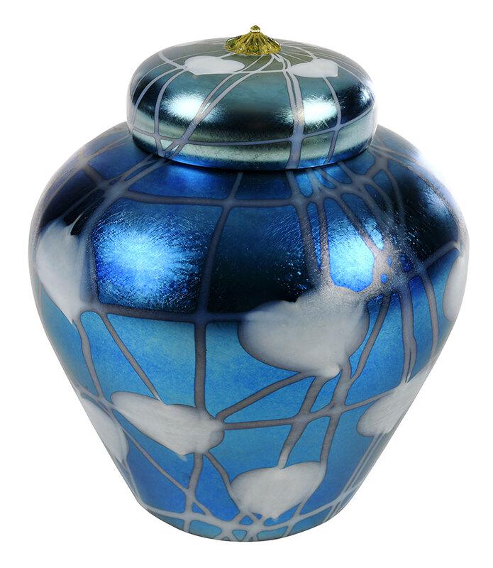 Durand Iridescent Blue Art Glass Ginger Jar: American, 20th century, lidded ovoid jar in iridescent blue, decorated with white heart leaf and vine motif, lid with golden rosette finial, faintly signed on base "Durand", 9 x 8 in. - Provenance: Fr