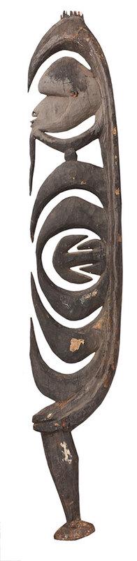 Carved Wood Kamanggabi Cult Hook Yipwon Figure: Papua New Guinea, Arambak Tribe, Karawari River region, 20th century, large dense wood carving of stylized side profile of a human face with small carved ears, concentric hooks center that rises from 