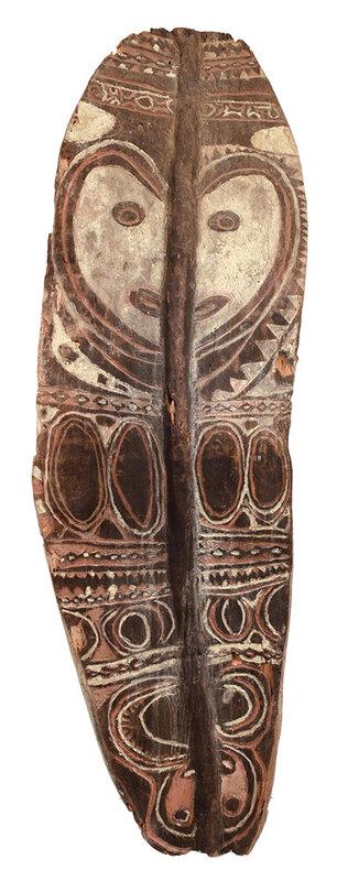 Large Carved and Painted Wooden Shield: probably South Pacific, 20th century, paint decorated with stylized central face, carved vertical ridge extends center, bark covered back with holes and handle, 60 x 70 in. - Provenance: Private Colle