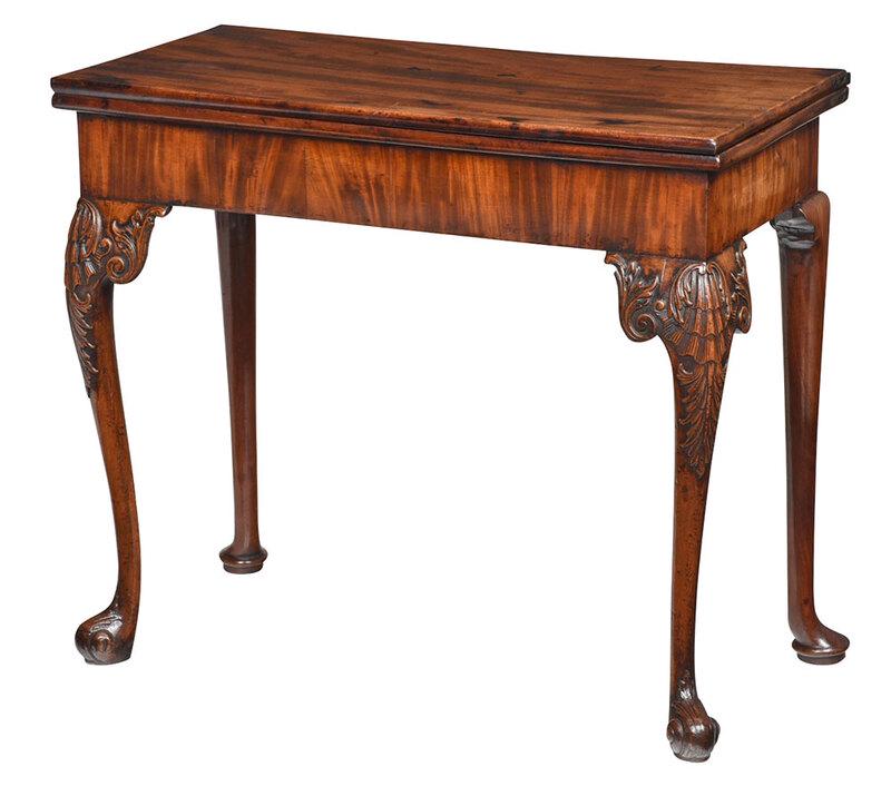 George II Mahogany Concertina Action Games Table: Probably American, late 18th/early 19th century, finely scrolled crest centering a shell patera, line inlaid frame over similarly scrolled base, old possibly original mirror plate with gilt surround, 