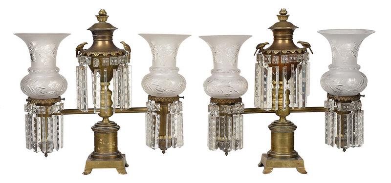 Pair of Classical Two Arm Argand Lamps: American or British, early 19th century, urn form central oil reserve mounted with eagles and hung with prisms, two arms supporting trumpet form shades cut with leaves and flowers, on circular socle a