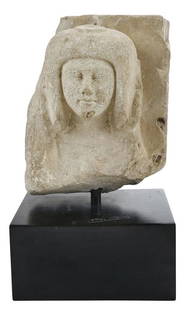 Egyptian Limestone Fragment Bust: 18th Dynasty, 1540-1292 B.C., a man or woman with hands raised to ears, limestone, 8-3/4 x 7 x 5-1/2 in. with lacquered wood base, 3-5/8 x 7-3/8 x 4-5/8 in. - Note: This lot will be accompanied by a