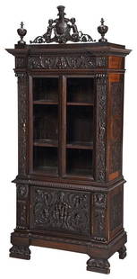 Italian Renaissance Style Bookcase Cabinet: back stamped "G.Pizzati Vincenza", late 19th century, with putti figural crest centering a heraldic crown, single case construction, figural and lion mask carved pilasters, upper section with beveled