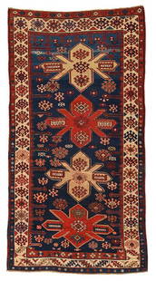 Kazak Rug: 20th century, four polygonal medallions on a dark blue field, ivory border with medallions on three sides, one end with leaf and wine glass design, 6 ft. 9 in. x 3 ft. 6 in. - Provenance: Private Coll