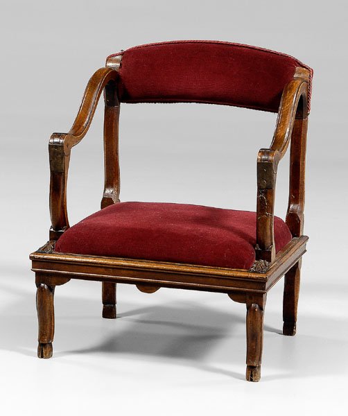 Lady's French prayer chair,: leaf-carved arm terminations and hoof feet, red velvet upholstery, 19th century, 30 x 23-3/4 x 21 in. Break and repair to one arm support with associated patch, scattered pest damage with minor loss t