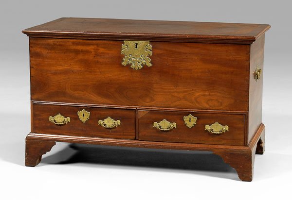 Chippendale mahogany lift-top chest,: top with iron strap hinges and open interior, dovetailed drawers with oak linings, straight bracket feet, very fine original engraved brass pulls and escutcheons, batwing brass carrying handles, Briti
