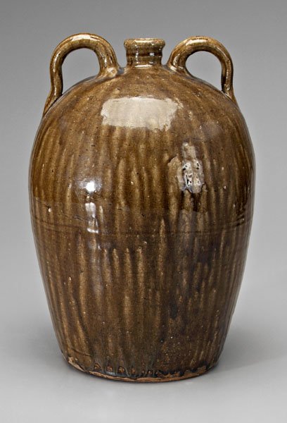 Alkaline glaze double-handle jug,: runny dark olive alkaline glaze, indistinct mark on one handle, probably Catawba Valley, North Carolina, 19th century, 16-1/2 in. Normal surface crazing and abrasions, excellent condition.