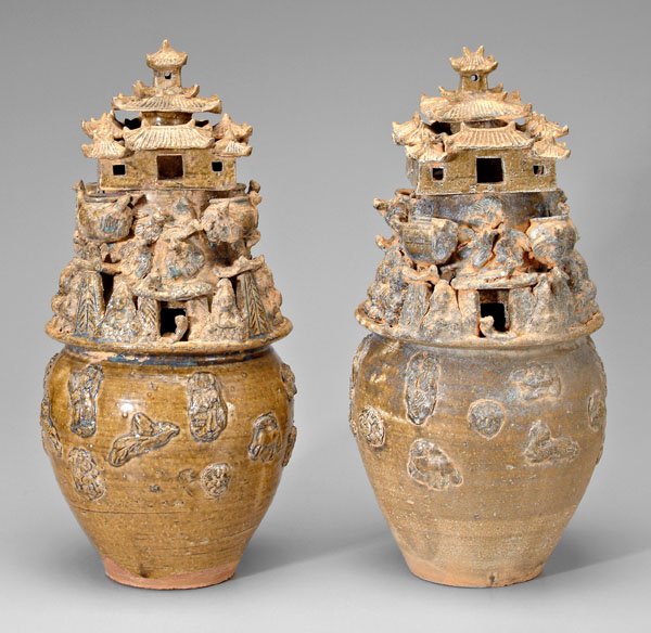 Pair [yue] ware funerary jars:: Western Jin Dynasty style, applied figures of men and animals below multi-tiered building embellished with [bodhisativas], birds, pots, 20th century, 20 in. One jar with repair to one roof corner, los