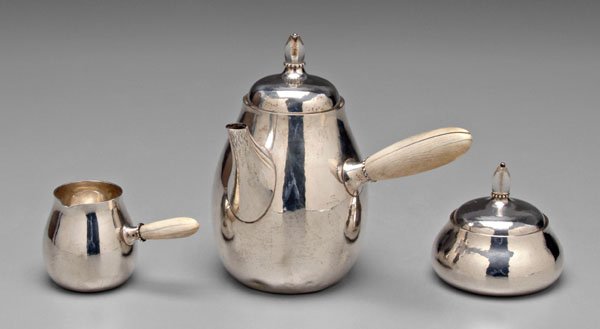 Georg Jensen sterling coffee service,: Georg Jensen design No. 80A, bone handles, clear acrylic finials, 6-3/4 in. coffeepot, matching creamer and covered sugar, marks for George Jensen, Denmark, inscribed on bottom "H/T*E" and "1936", 21.