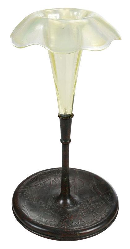 Tiffany Favrile Trumpet Vase with Bronze Base: American, early 20th century, iridescent opaline vase with everted ruffled rim, mounted to a stemmed bronze base in the Pine Needle pattern, marked "Tiffany Studios New York" with logo, overall 9-1/2