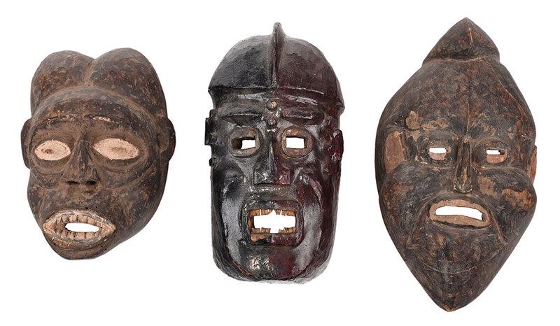 Group of Three West African Carved Wood Masks: Cameroonian/Nigerian, possibly early 20th century, comprising: one Western Grassfields area, carved face form with lobed hairstyle and open mouth, traces of white pigment coloring eyes and teeth, 13 x