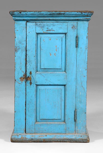 Blue-painted paneled cupboard,: mahogany(?) throughout, pit-sawn lumber with rosehead nails, single-panel door with shelved interior fitted with one drawer, old bright blue paint, probably Colonial, 18th/19th century, 47-3/4 x 30 x 