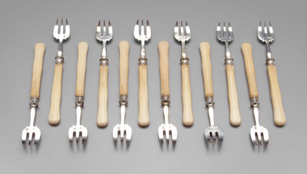 Twelve French silver oyster forks,: shaped and carved ivory handles, marks for Hippolyte Thomas, French, mid 19th century, .950 fine, 5-3/4 in. Ivory discolored and with cracks.
