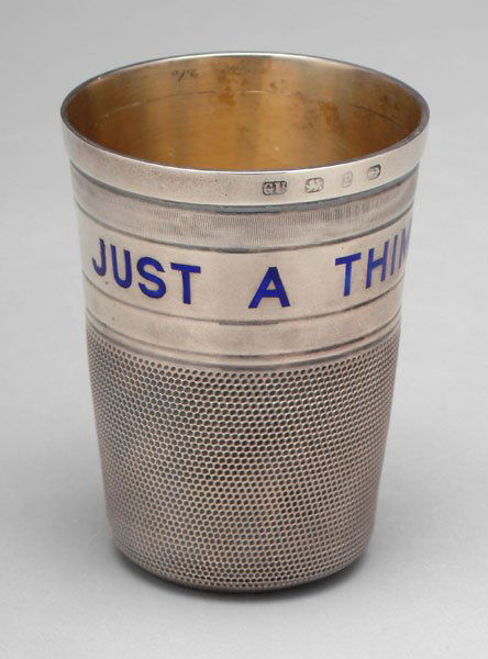 English silver thimble jigger,: blue-enameled lettering "JUST A THIMBLEFUL", marks for George Unite, Birmingham, 1898, no monogram, .925 fine, 2.58 oz.T., 3 x 2-1/4 in.; with fitted case. Marks rubbed, small dents, light scratches;