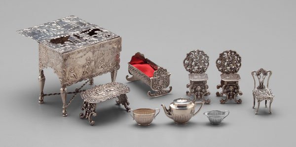 Nine pieces miniature silver:: Continental silver table box, possibly Dutch, 3-1/4 x 3-3/4 x 2-1/4 in.; three pieces Continental silver, two 2-1/2 in. chairs, 1-1/4 x 2-1/4 in. table; cradle, Birmingham, 1911, 1-3/4 x 2-1/4 in.; ch