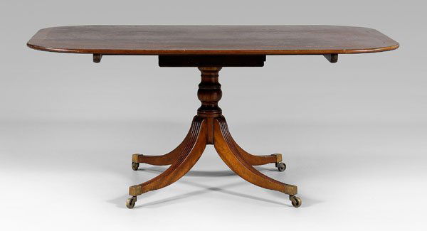 Regency style mahogany dining table,: banded mahogany top over turned support, saber legs and brass casters, 20th century construction, 26-1/4 x 67 x 45-1/2 in. Top banding with some cracks, other surface dirt and mildew, other normal sur