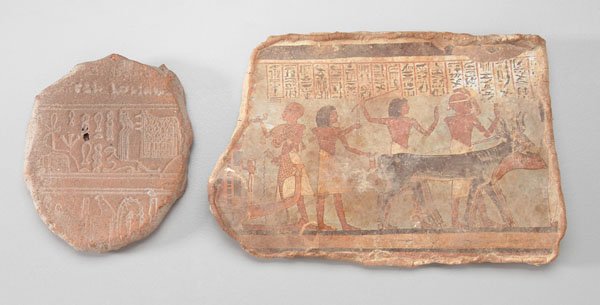 Two hieroglyphic fragments:: one with finely detailed figures and animals, fabric backing, modern copy, 5-3/4 in.; one with traces of animal figures with architectural elements, 3-1/2 in. Both with chips, losses.