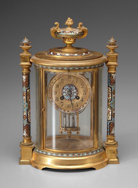 Champleve clock,: urn pediment above oval case, glass sides with gilt brass mounts, French brass works, ornate pendulum and side columns with matching champleve, with mercury (handle with care), 14-1/2 in. Finish losse