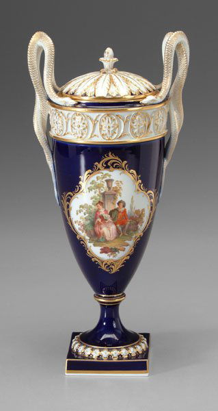 Meissen porcelain urn,: double snake handles, hand-painted reserve with lovers in exterior setting on cobalt ground with gilt highlights, blue crossed swords mark under glaze, 20th century, 14 in. Excellent condition. Proven