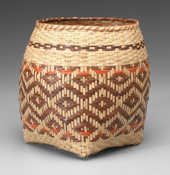 Cherokee river cane basket,: square-to-round design, wrapped oak split rim, brown and orange weavers, probably walnut and bloodroot, 1950s-1960s, 11-1/4 in. Excellent condition.