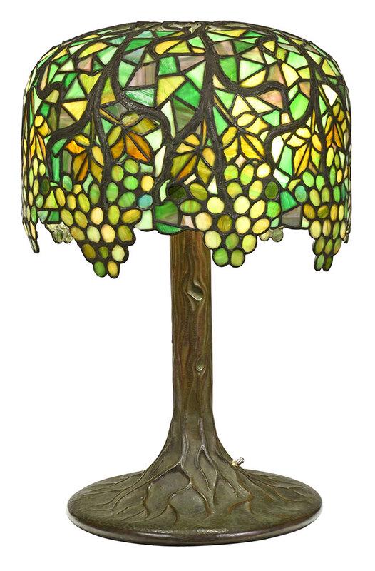 Rare Riviere Studios Slag Glass Lamp: American, early 20th century, the base stamped "Riviere Studios New York", leaded slag glass shade in gold and green with grape vine motif, on hammered and patinated copper tree form base, flame finia