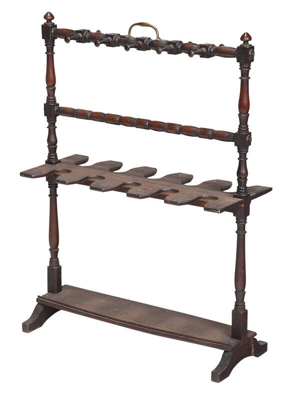 Mahogany and Brass Mounted Gun Rack: late 19th century, mahogany trestle form frame with turned supports and brass carrying handle, 38 x 28 x 11 in. Provenance: Estate of T. Kenneth and Karin Ellis, "Stepping Stones", Hot Springs, Virgin