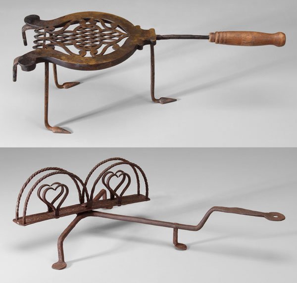 Wrought iron toaster, trivet: rotating toast holder with heart-shaped mounts below spiraled arches over tripod penny feet, probably American, late 18th/early 19th century, 6 x 16-3/4 x 14 in., [scattered light rust, otherwise good