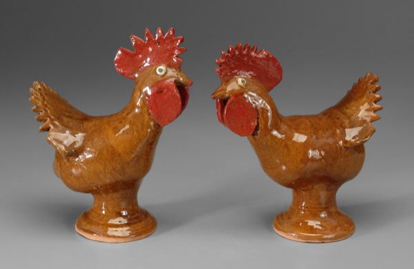 Two Reggie Meaders stoneware roosters: (White County, Georgia, 1916-2000), each with brown glaze, green-painted eyes, red-painted combs, signed under tails "Reggie Meaders", 12-1/4 in. and 13 in. Excellent condition, minor glaze anomalies