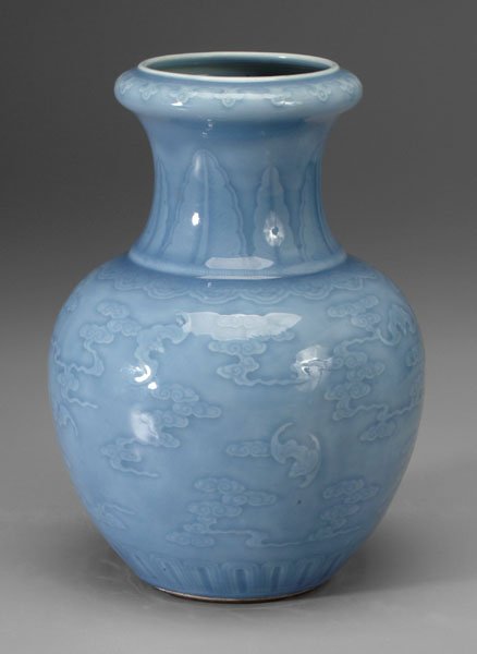 Chinese sky blue vase,: molded bats among clouds, base with old paper label, 19th century, 12 in. Minor scratches, 1 in. under-glaze crack. Provenance: Formerly Collection of Thomas English Cody.